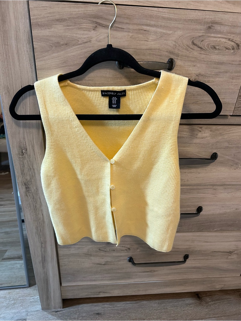 Yellow sleeveless buttoned knit top